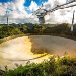 Planet Heat Spike Alarms NASA Arecibo radio telescope dish in a lush valley