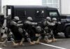 SWAT Foils Alleged Texas Capitol Attack Tactical team advances beside an armored vehicle
