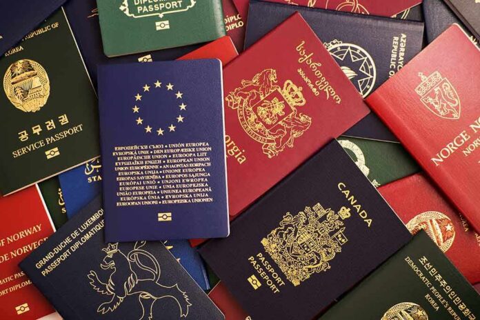 shutterstock_1367373428 Assorted international passports spread out on a surface