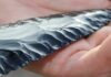 80,000-Year Shock: Arrows in Central Asia? Hand holding a flaked obsidian blade