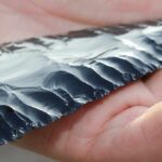 80,000-Year Shock: Arrows in Central Asia? Hand holding a flaked obsidian blade