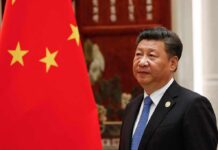 Trump Did Something Presidents Rarely Do for Xi Xi Jinping standing beside a Chinese flag