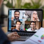 Laptop screen showing a four-person video conference call