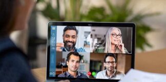 Laptop screen showing a four-person video conference call