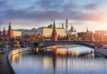Nuclear Bros Tighten War Pact Kremlin complex by a river at sunset
