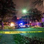 Burglary Call Unmasks Grisly Double Kill Police car blocks residential street at night behind caution tape