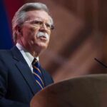 John R. Bolton speaking at a podium