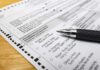 Feds Bust Cash-For-Votes Scheme Ballot paper with pen on wooden surface