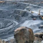 Trump Declares National Emergency Over Minerals Open-pit mine with haul trucks and excavators on terraced roads