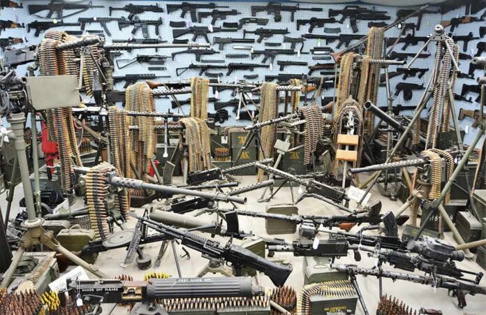 shutterstock_1967096365 Room filled with machine guns and ammunition belts