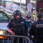 Domestic Terror Scare Erupts At 26 Federal Plaza Police officers in tactical gear near a patrol vehicle at night