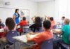 Judge Blocks State’s ‘No Religion’ Rule Teacher leading classroom discussion with students raising hands