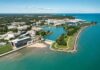 Billionaire Drops Record $3 BILLION University Gift aerial view of a lakeside university campus with lagoon and curved shoreline
