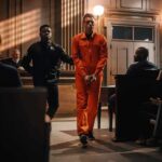 Berkeley Dorm Horror Sparks Cover-Up Questions Defendant in orange jumpsuit escorted by officer in courtroom