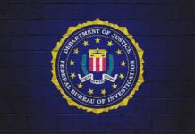 Huge Terror Numbers, Zero Method FBI seal painted on a dark brick wall