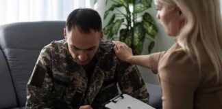 Soldier in camouflage receives support from a counselor