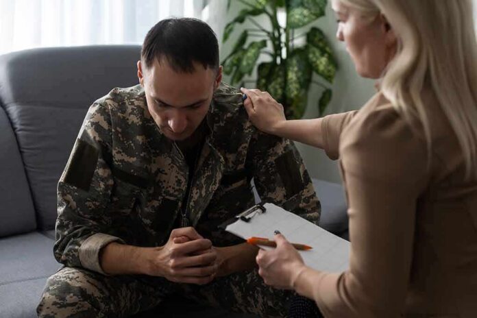 shutterstock_2110380992 Soldier in camouflage receives support from a counselor