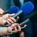 Talarico Says ‘Not Transitioning Kids Is Abuse’ Reporters holding colorful microphones
