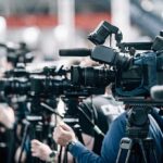 Stoppage-Time Stunner Buries Belgium Broadcast cameras on tripods at a press event