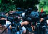 Navy Tests New Backup for GPS Jamming TV news cameras crowding together at an outdoor event