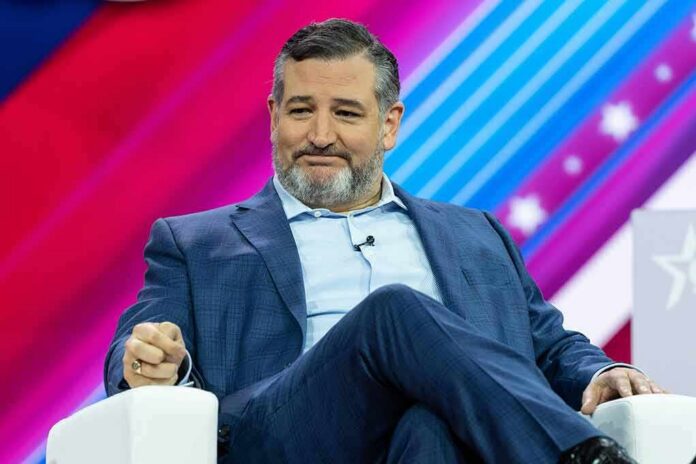 Ted Cruz seated on stage in a blue suit