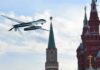 military drone flying near ornate red-brick towers