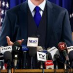 Trump Names Himself Iran’s Top Target A speaker at a press conference with multiple microphones in front of them