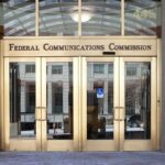 Federal Communications Commission building entrance with gold doors