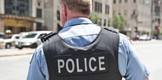 Police officer in uniform from behind on a city street