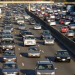 A busy highway filled with cars in a traffic jam