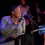 Woman speaking at a podium with a microphone