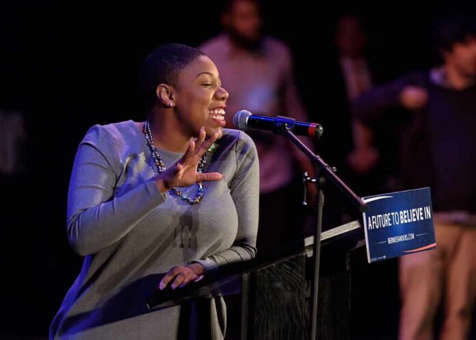 Woman speaking at a podium with a microphone