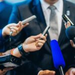 OPINION: Fauci’s Greatest Lie Should Land Him in Electric Chair Man in suit surrounded by microphones at press conference