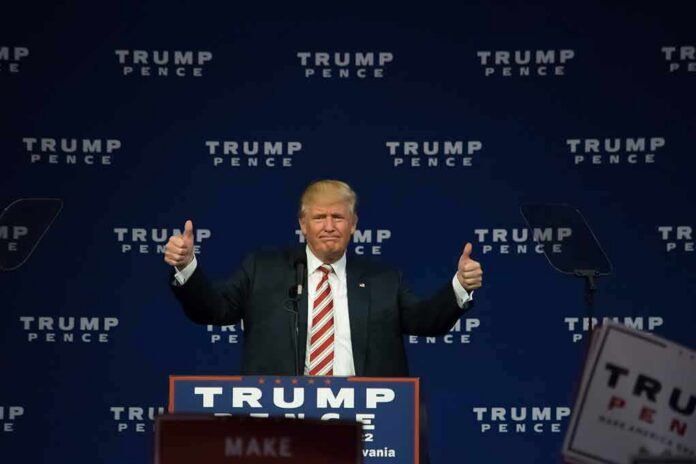 shutterstock_487546267 man at podium giving two thumbs up