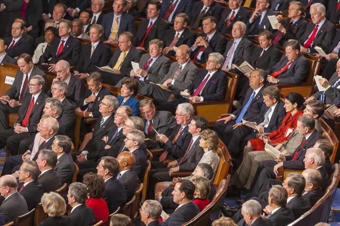 Rick Santorum, Samuel Bodman, Bob Bennett, La Parka, Mike Leavitt, Trent Lott, Saxby Chambliss, Richard Shelby, Spencer Abraham, Gordon H. Smith, Stephen Hadley, Richard M. Burr, Pat Roberts, John Cornyn, Joshua Bolten, Wayne Allard, Jerzy Eisler, Alphonso Jackson, John Warner, Mel Martinez, Olympia Snowe, David Vitter, Lindsey Graham, Johnny Isakson, Judd Gregg, John McCain, Andrew Card, Susan Collins, George Allen, Lincoln Chafee, Norm Coleman, Lamar Alexander, Richard Lugar seated in a large audience
