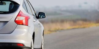 Silver hatchback car on a rural road