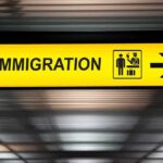 Illegals Being Deported to World’s Most Dangerous Countries Immigration sign with arrow in airport