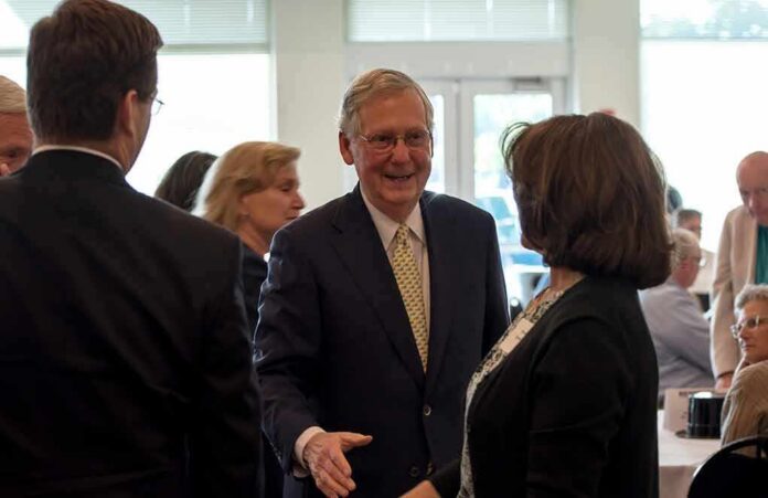 shutterstock_669478348 Mitch McConnell greets Eileen Caddy at a gathering