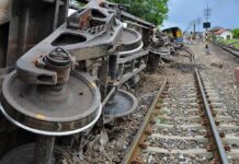 Russia Kills Nine Nationwide Overturned train cars beside railway tracks