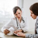 Medicaid Ban Fallout—Access Vanishes Overnight Doctor consulting a patient at a desk