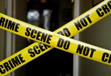 Woman Fights Off 3 Masked MUGGERS Yellow crime scene tape crossing a doorway