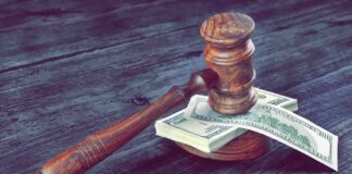 Judge's gavel resting on a stack of US dollar bills