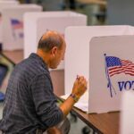 Voter fills out ballot at a polling booth