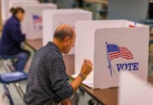 Voter fills out ballot at a polling booth