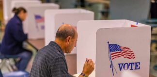 Voter fills out ballot at a polling booth