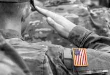 Pentagon Gives Troops an Entire Day to VOTE Soldier saluting with an American flag patch on sleeve