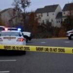 Sheriff's vehicles behind yellow do-not-cross tape