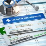Your Health Insurance Could Get HUNDREDS More Expensive Health insurance cards on medical forms with stethoscope