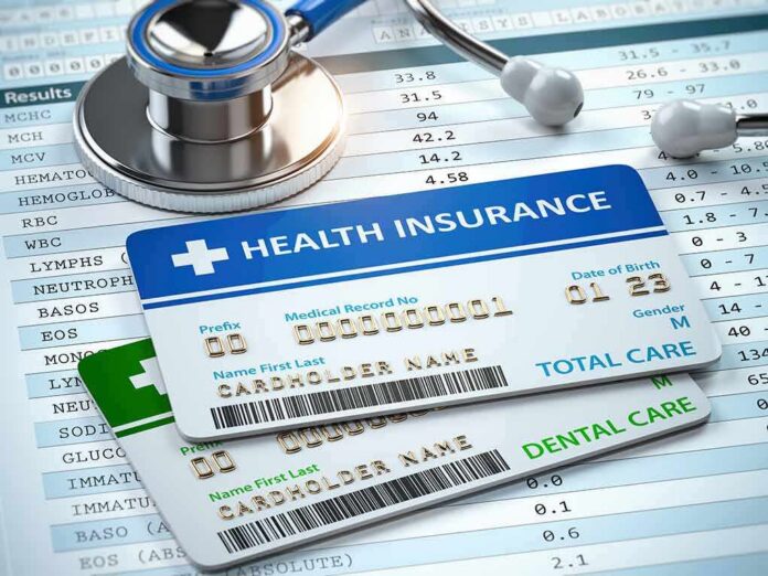 shutterstock_1315569938 Health insurance cards on medical forms with stethoscope