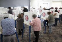 Top Pollster Says Midterm Polls Are MISSING Something Voters fill out ballots at polling booths in a busy voting room